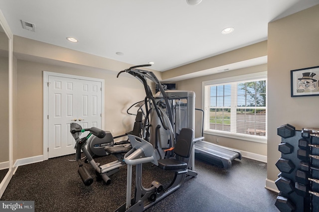 workout area featuring baseboards, visible vents, and recessed lighting