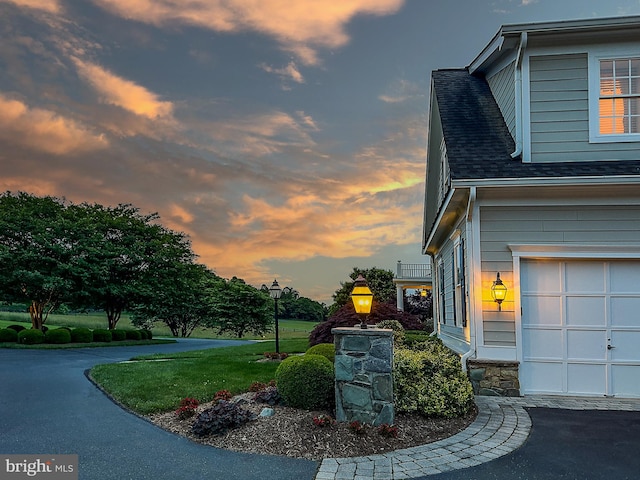 property exterior at dusk with a garage