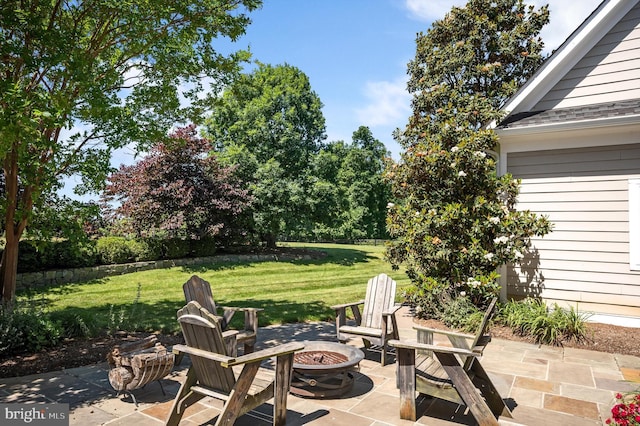 view of patio with a fire pit