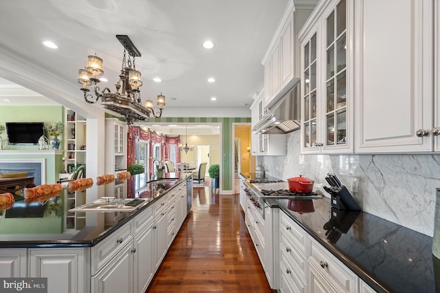 kitchen featuring white cabinets, dark countertops, and ornamental molding