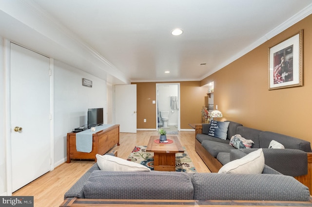 living room featuring ornamental molding and light hardwood / wood-style floors