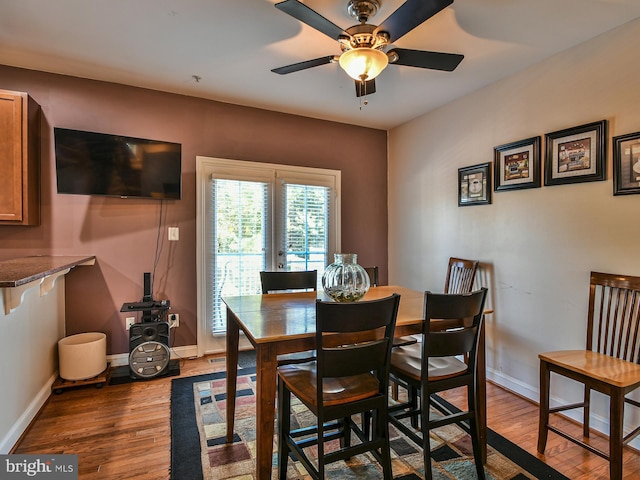 dining room with ceiling fan and light hardwood / wood-style flooring