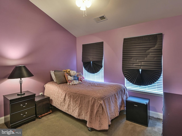 bedroom featuring carpet floors, lofted ceiling, and multiple windows