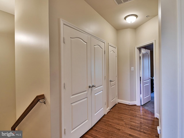 corridor featuring dark wood-type flooring