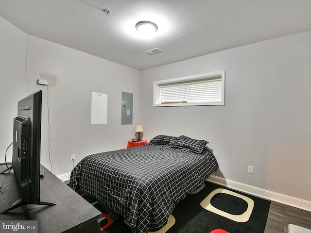 bedroom with wood-type flooring and electric panel