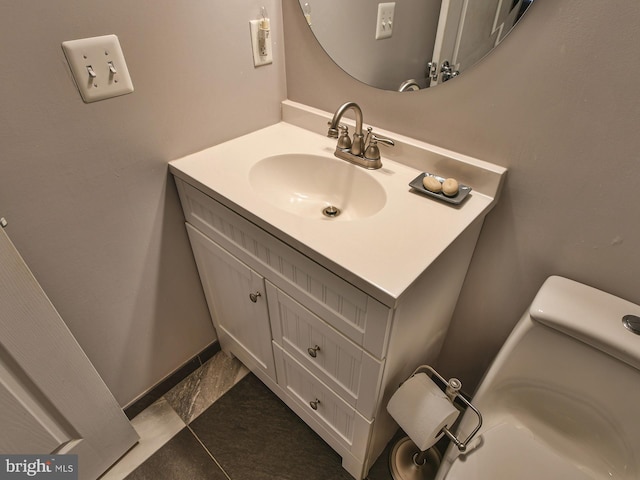 bathroom with tile patterned floors, vanity, and toilet