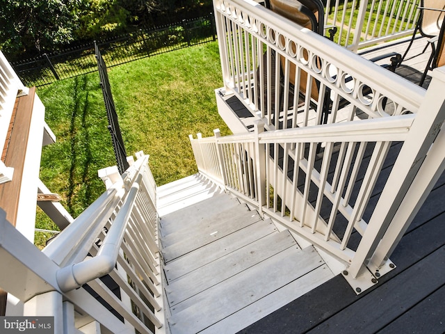 wooden terrace featuring a yard