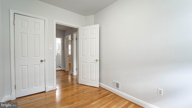 spare room with light wood-type flooring