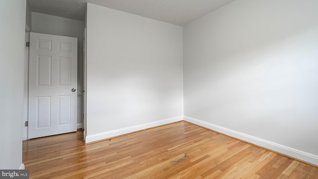 empty room with wood-type flooring