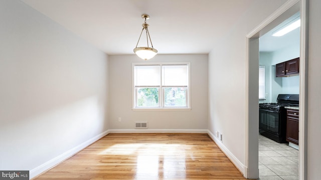 unfurnished dining area with light wood-type flooring