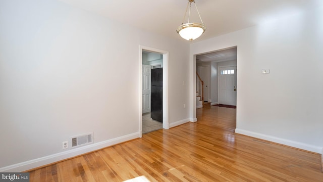 empty room with hardwood / wood-style floors