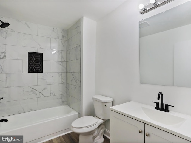 bathroom with shower / bath combination, wood finished floors, toilet, and vanity