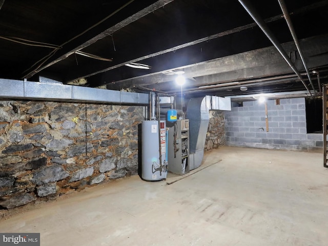 unfinished below grade area featuring water heater