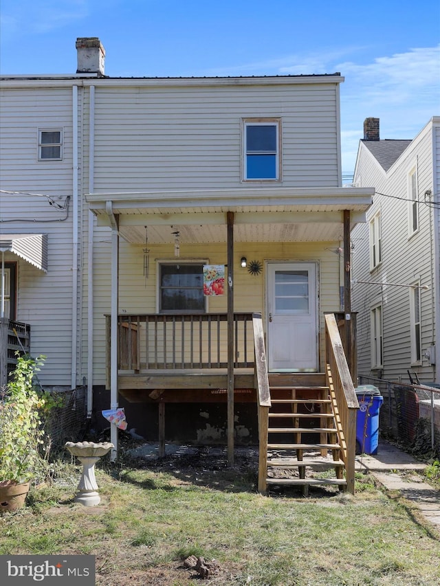 back of house featuring a porch