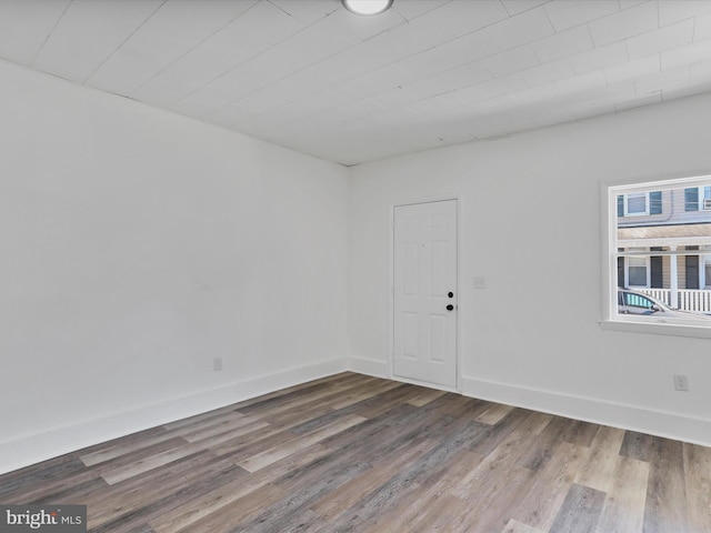 unfurnished room with wood finished floors and baseboards
