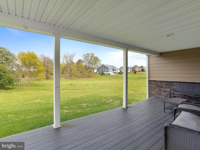 wooden terrace featuring a lawn
