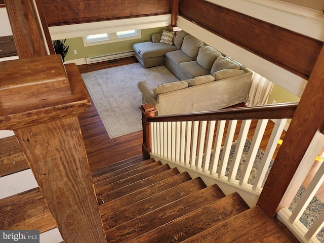 stairs featuring hardwood / wood-style flooring and a baseboard heating unit