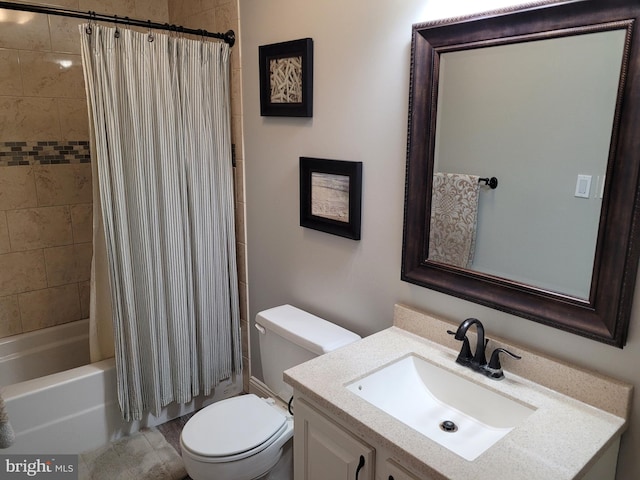 full bathroom featuring vanity, shower / bath combo with shower curtain, and toilet