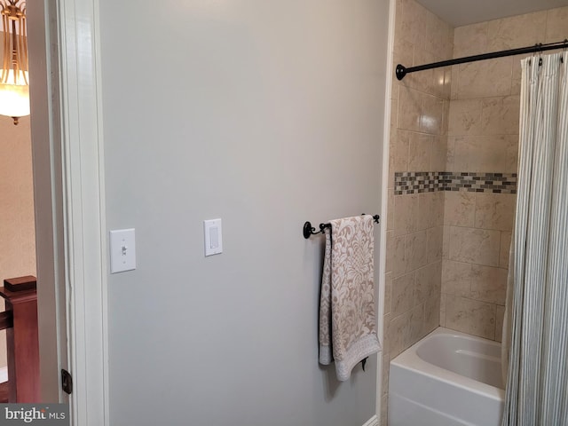 bathroom with shower / bath combo with shower curtain