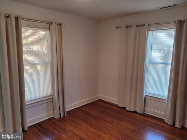 spare room with dark wood-type flooring