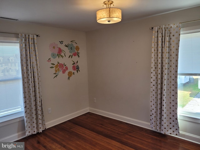 empty room with dark hardwood / wood-style flooring