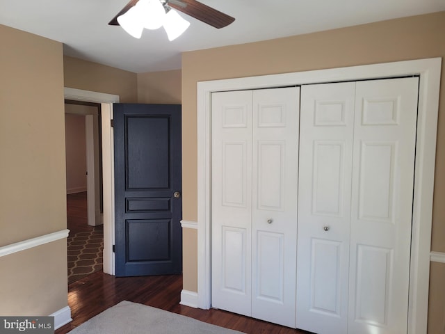 unfurnished bedroom with a closet, ceiling fan, and dark hardwood / wood-style floors