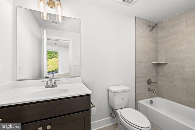 full bathroom featuring tiled shower / bath combo, vanity, and toilet