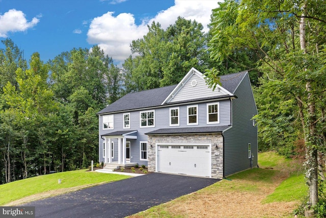 view of front of property with a garage and a front lawn