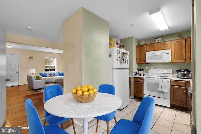 kitchen with light tile patterned floors and white appliances