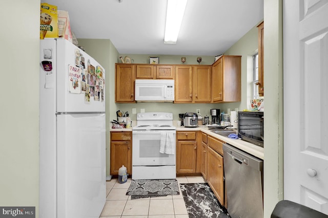 kitchen featuring light tile patterned floors and white appliances