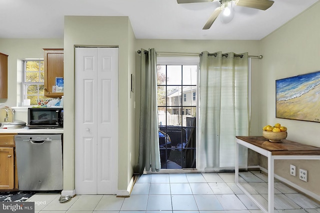 kitchen with ceiling fan, stainless steel dishwasher, and light tile patterned floors