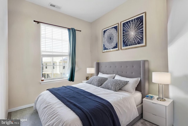 carpeted bedroom with multiple windows