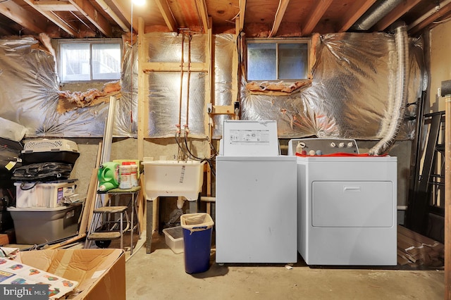 laundry area featuring sink and washer and clothes dryer