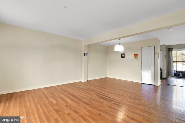 unfurnished room with hardwood / wood-style floors