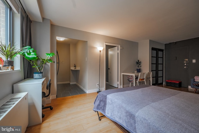 bedroom with wood-type flooring