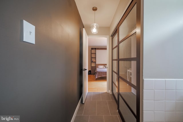 hallway with dark tile patterned flooring