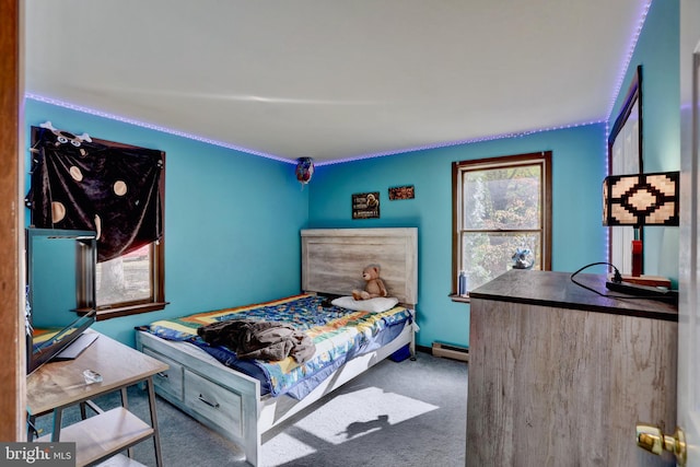 carpeted bedroom with a baseboard radiator