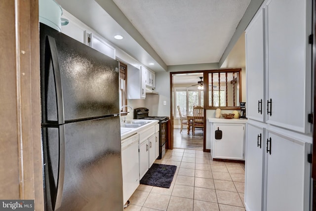 kitchen featuring white cabinetry, ceiling fan, black appliances, and light tile patterned floors