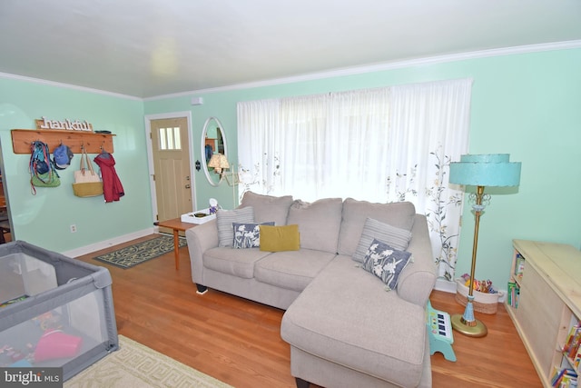 living room with ornamental molding, hardwood / wood-style floors, and a healthy amount of sunlight