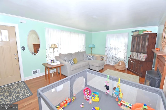 living room with wood-type flooring and ornamental molding