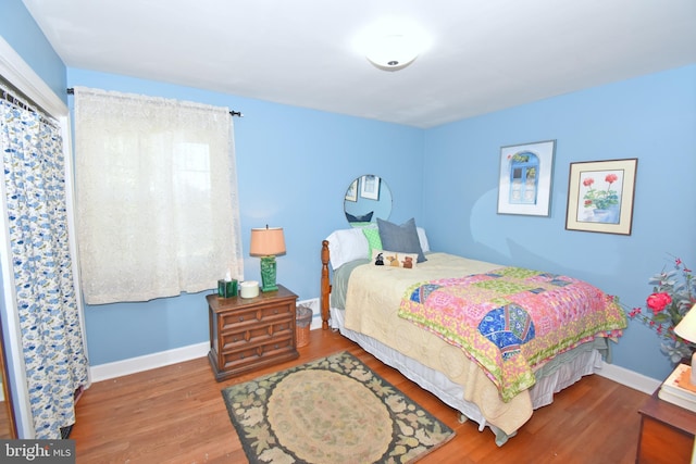 bedroom with hardwood / wood-style flooring