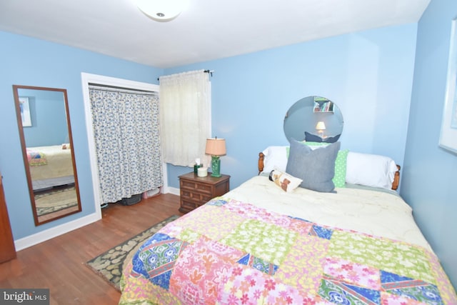 bedroom with dark hardwood / wood-style flooring