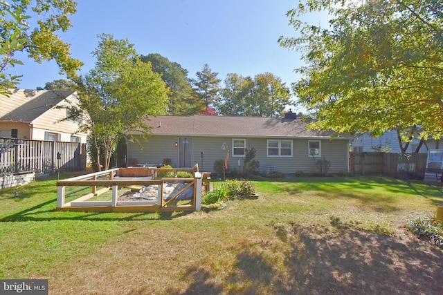 rear view of house with a yard