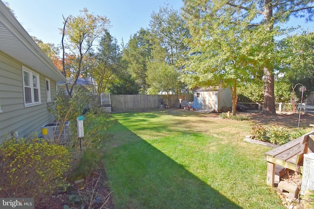 view of yard with a storage shed and central AC unit