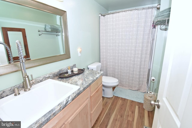 bathroom with toilet, hardwood / wood-style flooring, vanity, and a shower with shower curtain