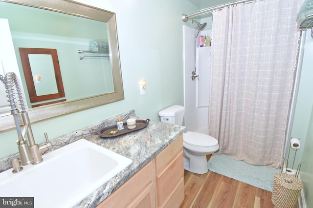 bathroom with vanity, toilet, a shower with curtain, and hardwood / wood-style floors