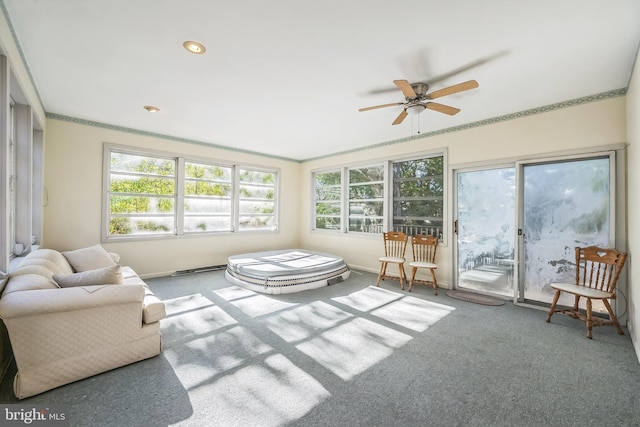 sunroom / solarium with a healthy amount of sunlight and ceiling fan