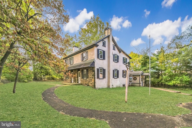 view of side of property with a lawn