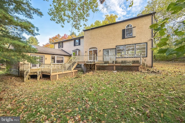 back of property featuring a wooden deck