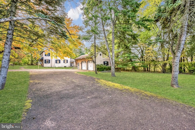 view of front of home with a front lawn and a garage